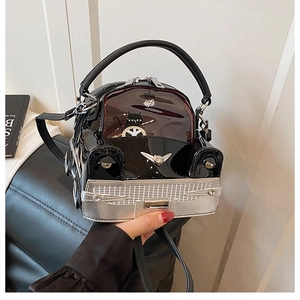 Detail of creative car-shaped handbag showing metallic grille and cat driver window