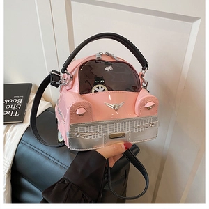 Close-up of pink car-shaped handbag with cartoon black cat and black leather handle