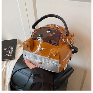 Detail of creative car-shaped caramel patent leather handbag with cat pattern window