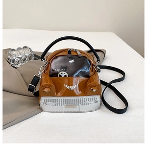 Macro shot of car-shaped crossbody bag featuring glossy patent leather and silver grill details
