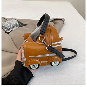 Detailed shot of brown lacquer car-shaped handbag with silver trim and crossbody strap
