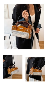Detail of creative vintage car-shaped handbag featuring brown patent leather and silver accents