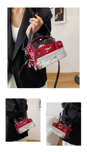 Detail of red vintage car shaped crossbody bag with glossy patent leather finish