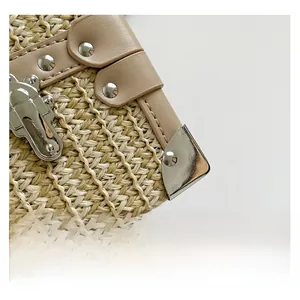 Detail showing woven straw texture with leather piping and silver metal snap closure
