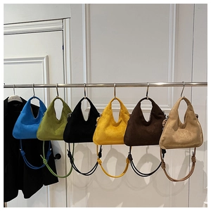 Collection of minimalist suede hobo bags in six vibrant colors with knot handle details