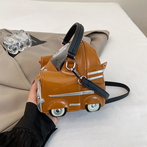 Creative car-shaped handbag in brown patent leather with metallic wheels and shoulder strap