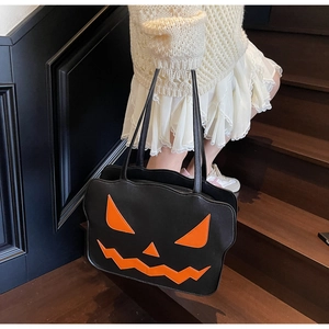 Kind trägt eine schwarze Halloween Kürbis-Einkaufstasche auf einer Holztreppe