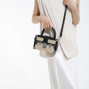 French straw woven box bag with black leather trim and silver metal lock closure