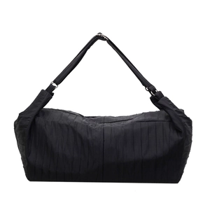 Detailed close-up showing the pleated texture and wide strap of this black nylon dumpling bag