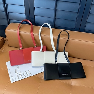 Three minimalist faux leather baguette underarm bags in red, white and black colors