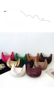 Detailed display of minimalist crescent shoulder bags in multiple vibrant colors