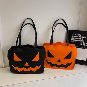 Halloween-Einkaufstaschen mit Kürbisgesicht in Schwarz und Orange auf Marmoroberfläche