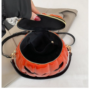 Detail view of pumpkin shaped bag interior with black lining and golden zipper hardware
