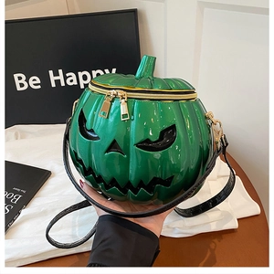 Detail view of bright green pumpkin bag with spooky face and golden double zippers