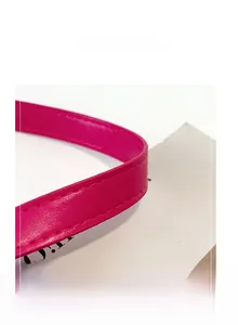Macro detail of high-quality fuchsia faux leather bag strap with fine stitching
