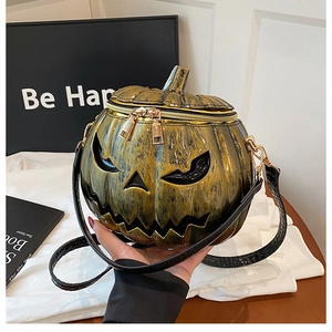 Detail showing the bronze pumpkin bag with crocodile texture strap and dual metal zippers