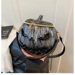Detail of pumpkin crossbody bag with marble texture and golden double zipper hardware