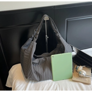 Deep grey nylon hobo bag featuring pleated texture and large capacity for commuting