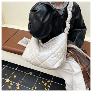 Quilted puffer tote bag in cream white featuring unique ruched straps for autumn style
