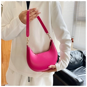 Detail of rose pink crescent hobo bag with gold hardware and smooth matte texture