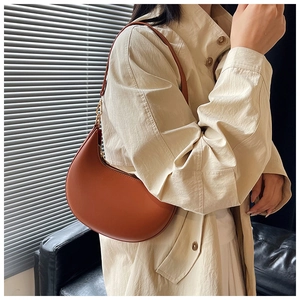 Chic caramel crescent shoulder bag with smooth leather finish and gold hardware detail