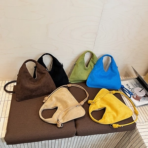 Suede dumpling bags in six colors with knotted shoulder straps and hollow handles