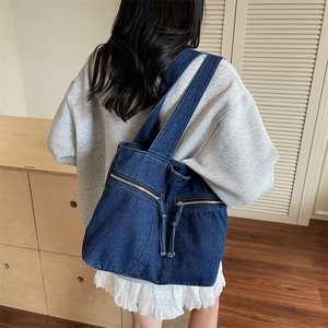 Retro denim tote bag in dark blue with front zipper pockets and wide shoulder strap