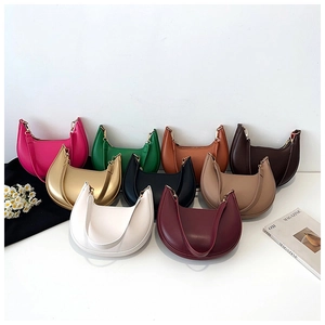 Multi-color display of crescent underarm bags in nine elegant hues with smooth texture