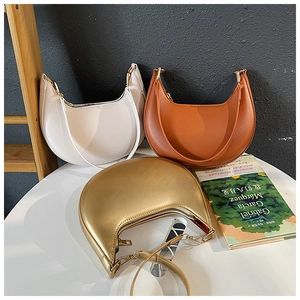 Three hobo shoulder bags in white, red and gold finishes with leather texture details
