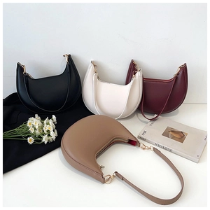 Flat lay of minimalist crescent underarm bags in black, white, burgundy, and khaki colors