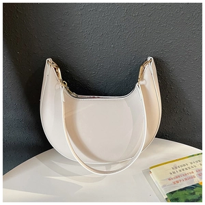 Detail shot of the white crescent hobo bag with gold hardware and matte leather texture