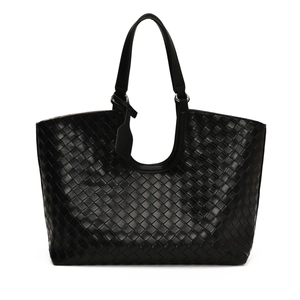 Close-up of black woven tote bag showing detailed Intrecciato synthetic leather pattern