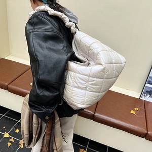 Quilted puffer tote bag in cream nylon with ruched straps and large capacity for daily use