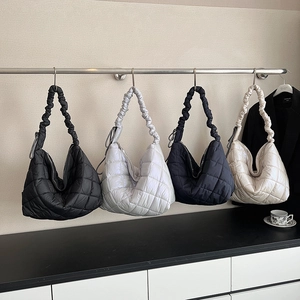 Quilted puffer tote bags in black, silver, navy, and cream with ruched handle details