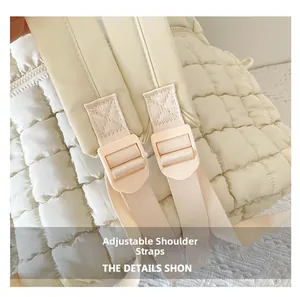 Detail view of the adjustable wide shoulder straps on a beige quilted cloud backpack