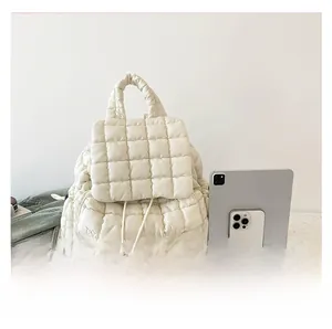 White quilted cloud backpack size comparison with tablet and phone showing large capacity