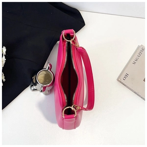 Detail of rose red crescent bag with golden zipper and red lining in lifestyle setting