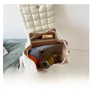 Spacious white quilted backpack showing large capacity for tablet and daily items