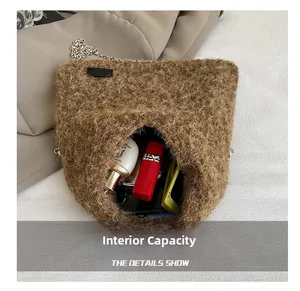 Detail view of brown plush crossbody bag interior showing storage for cosmetics