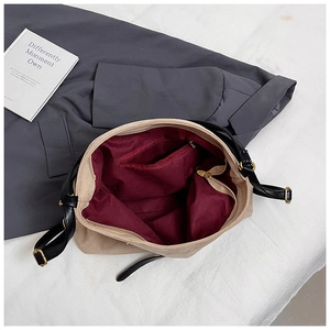 Top-down view of large beige suede tote with burgundy lining and interior zipper pocket