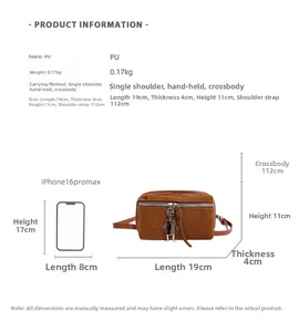 Size comparison of a brown PU lunchbox style crossbody bag with a smartphone for scale