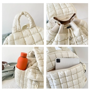 Detail of white quilted puffer backpack featuring drawstring closure and anti-theft back pocket