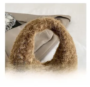 Detailed macro view of the thick brown plush handle on this stylish autumn handbag