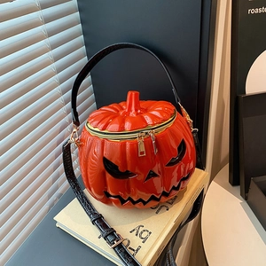 Quirky pumpkin shaped handbag with glossy orange finish and spooky face design