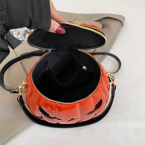 Chic orange pumpkin crossbody bag with black smiley face and premium gold hardware