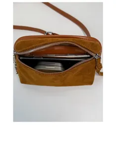 Interior view of brown suede crossbody bag showing capacity for phone and essentials