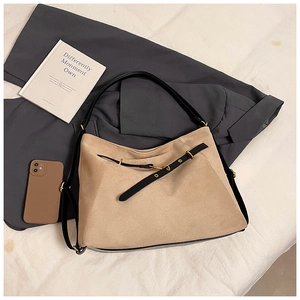 Top view of a khaki suede tote bag with black leather strap and metal buckle detailing