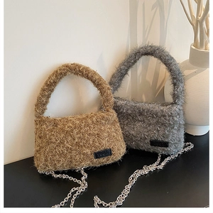 Detailed macro of brown and grey plush handbags with metal chains and leather tags