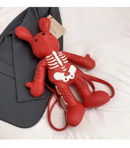 Detail of red rabbit backpack with white skeleton print and cross-stitched ear details