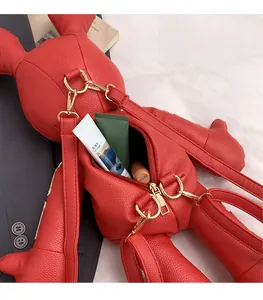 Detail of red rabbit shaped leather bag showing zipper opening and internal storage space